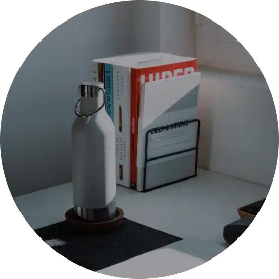 A table with a white bottle and box shelf